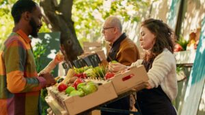 Vendors talking with a customer at a Farmers Market
